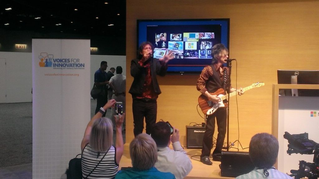 A guitarist and singer perform onstage as VFI is spotlighted at WPC Keynote event.