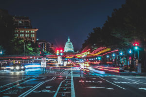 Washington, D.C. street filled with traffic at night.